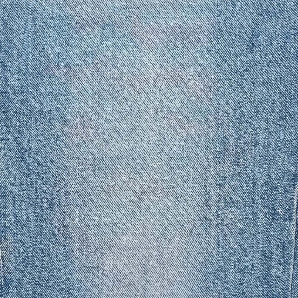 Light Blue Women's High-Waisted Cropped Barrel Leg Jeans — Lyra Light-Wash Curved-Seam - Denim Texture Closeup