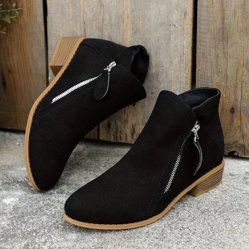 Black Women's Pointed Toe Ankle Boots — Mia Suede Zip-Up Block Heel - Pair Leaning Wall